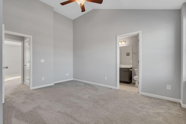 unfurnished bedroom with ensuite bath, baseboards, and light colored carpet