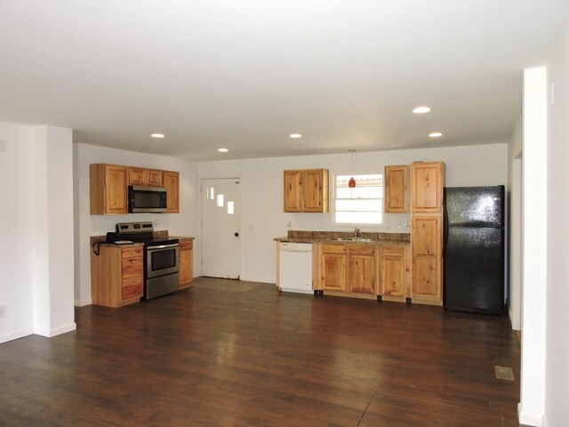 kitchen with dark wood-style floors, a sink, recessed lighting, and appliances with stainless steel finishes