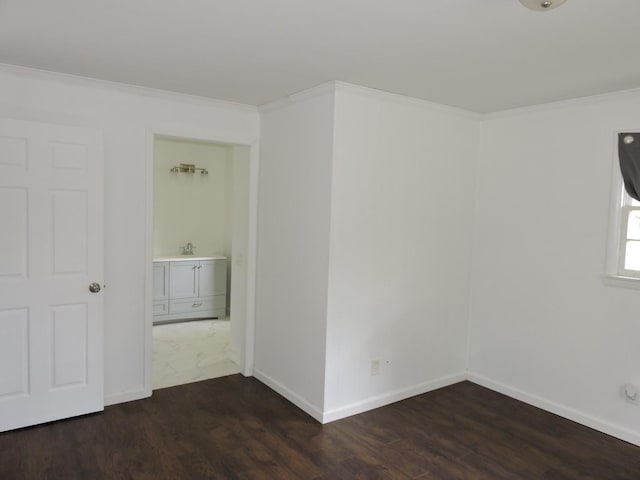 unfurnished room featuring baseboards, crown molding, and wood finished floors