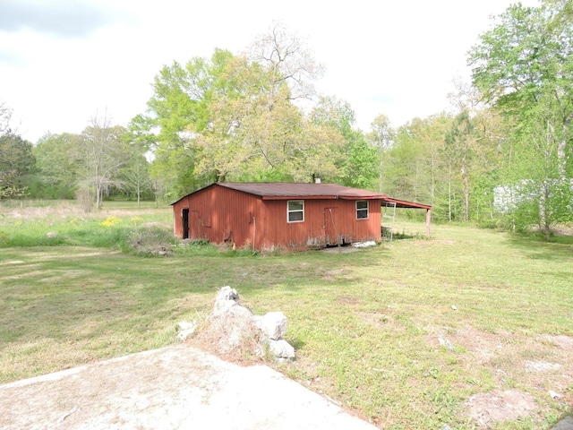 exterior space featuring an outbuilding and a view of trees