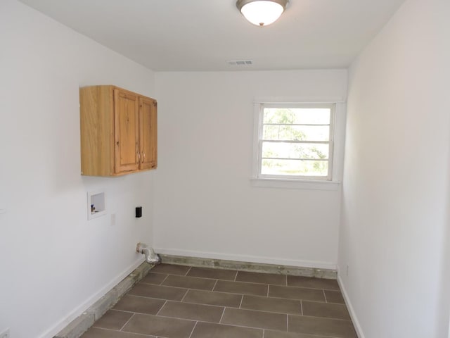 laundry area featuring baseboards, cabinet space, hookup for a washing machine, and visible vents