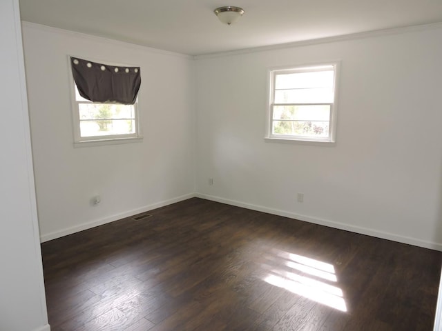 unfurnished room featuring baseboards, crown molding, and plenty of natural light