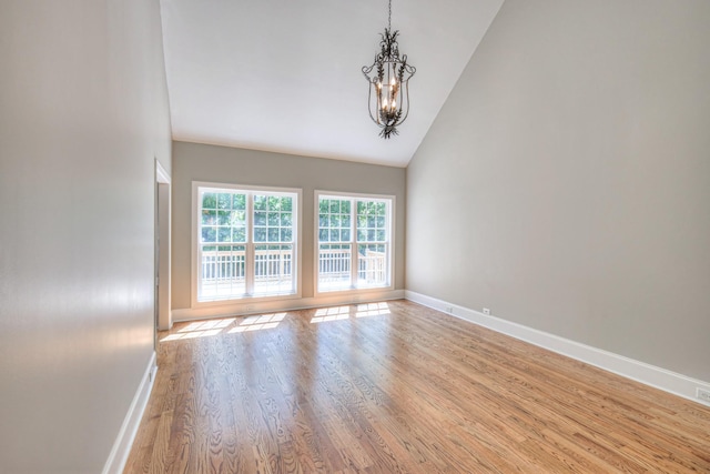 1178 Mccoury Ln, Spring Hill, TN 37174 - unfurnished room with an inviting chandelier, baseboards, light wood finished floors, and high vaulted ceiling