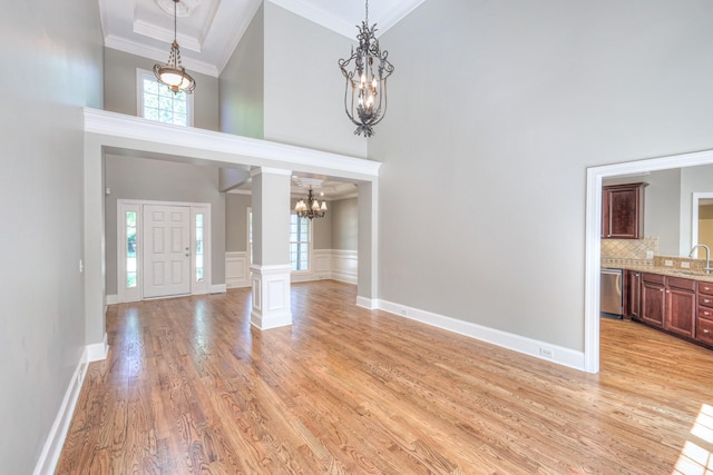 1178 Mccoury Ln, Spring Hill, TN 37174 - foyer featuring an inviting chandelier, ornamental molding, light wood finished floors, and a towering ceiling