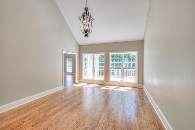 1178 Mccoury Ln, Spring Hill, TN 37174 - spare room featuring baseboards, light wood finished floors, a chandelier, and high vaulted ceiling