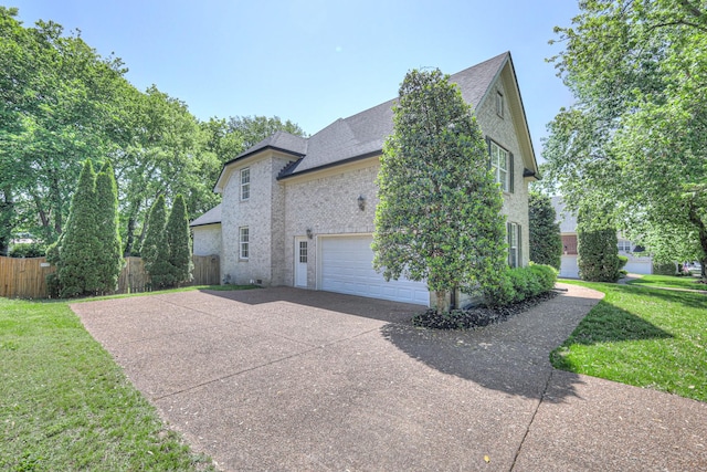 1178 Mccoury Ln, Spring Hill, TN 37174 - view of home's exterior with fence, brick siding, a shingled roof, a lawn, and driveway