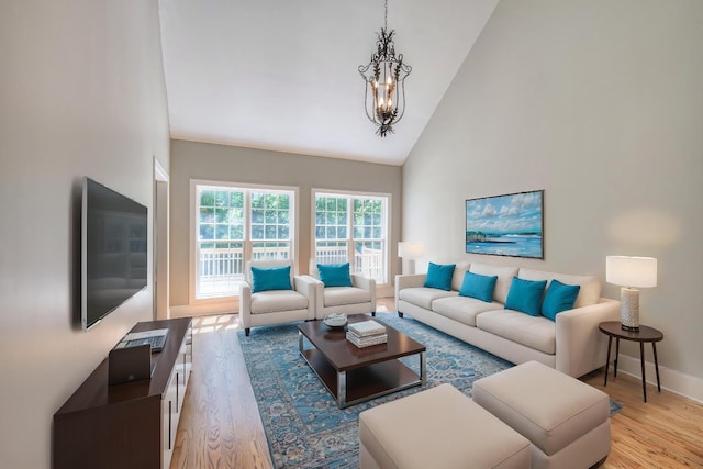 1178 Mccoury Ln, Spring Hill, TN 37174 - living area featuring high vaulted ceiling, baseboards, light wood finished floors, and a notable chandelier