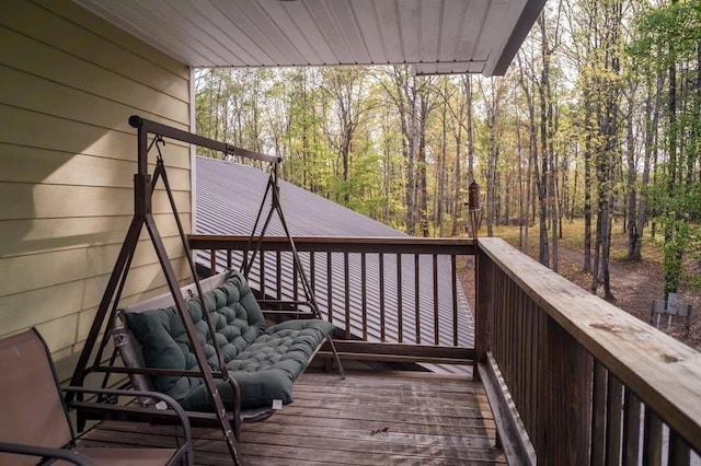 wooden deck with a wooded view