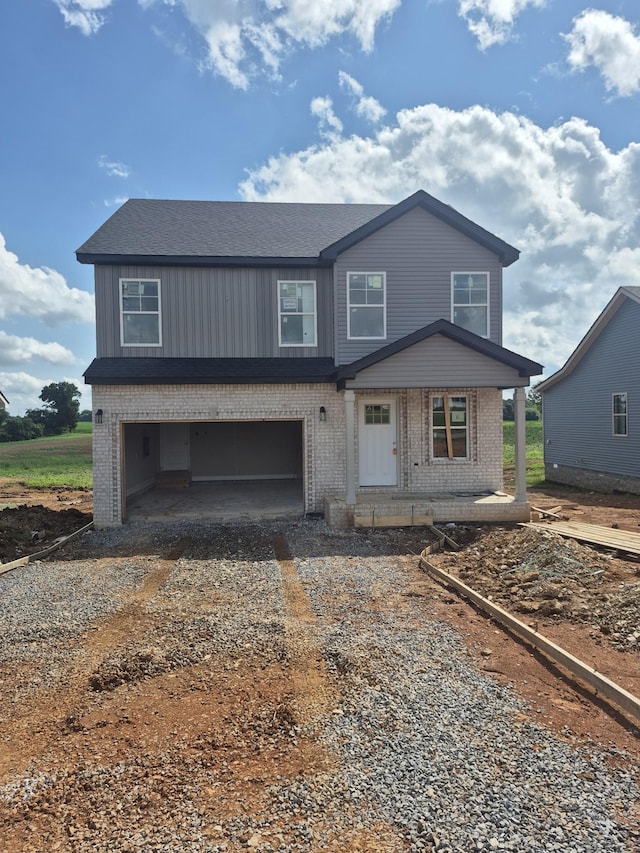 6 Hugh Hunter Rd, Oak Grove, KY 42262 - view of front facade with brick siding, dirt driveway, a garage, and a porch