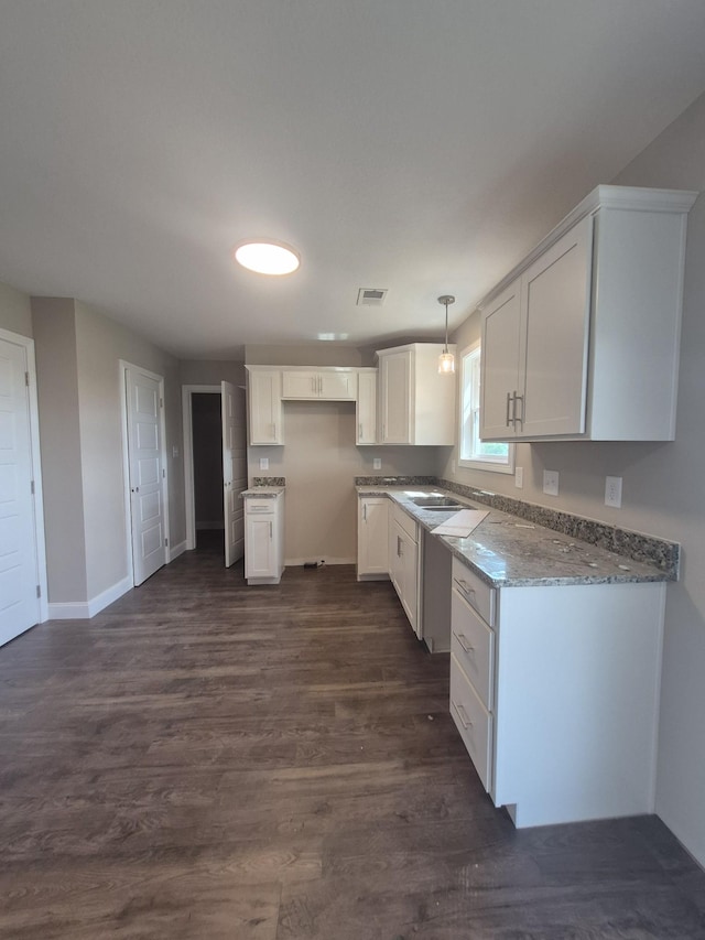 6 Hugh Hunter Rd, Oak Grove, KY 42262 - kitchen with white cabinets, dark wood finished floors, light stone countertops, and hanging light fixtures