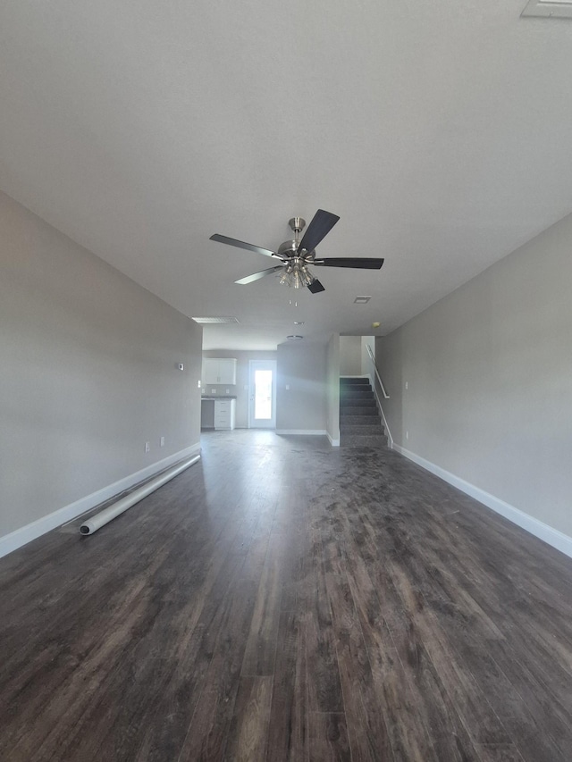 6 Hugh Hunter Rd, Oak Grove, KY 42262 - unfurnished living room with dark wood-type flooring, a ceiling fan, and stairs