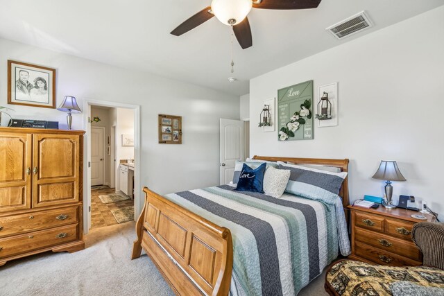 bedroom featuring visible vents, a ceiling fan, light carpet, and connected bathroom