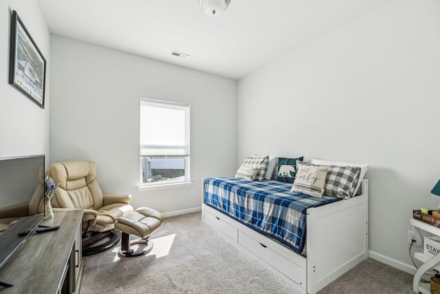 carpeted bedroom featuring baseboards and visible vents