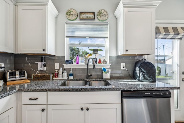 kitchen featuring stainless steel dishwasher, white cabinetry, and a sink