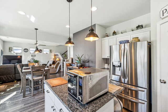 kitchen with stainless steel fridge with ice dispenser, open floor plan, wood finished floors, and a toaster