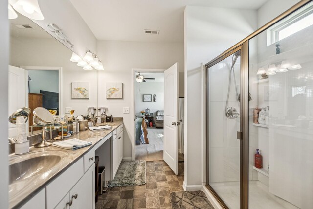 ensuite bathroom with a shower stall, a sink, connected bathroom, double vanity, and visible vents