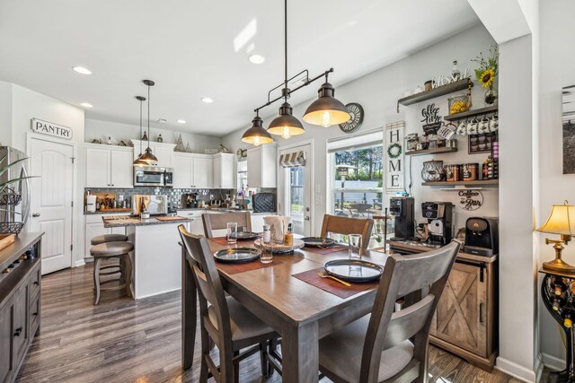 dining room with recessed lighting and dark wood finished floors