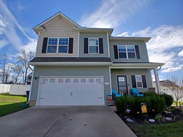 view of front of home featuring driveway, fence, a porch, and a garage