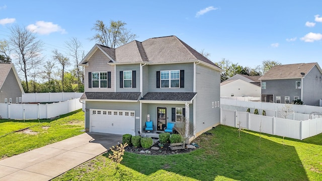 view of front facade with a garage, driveway, and a front lawn