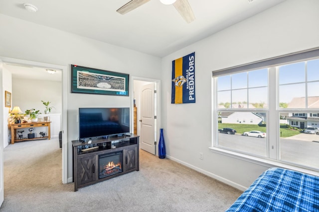 carpeted bedroom featuring baseboards and ceiling fan