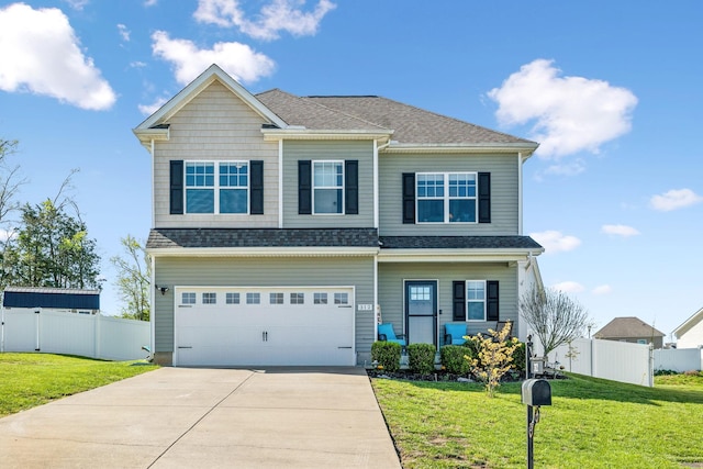 craftsman-style house with a front lawn, driveway, fence, and a garage