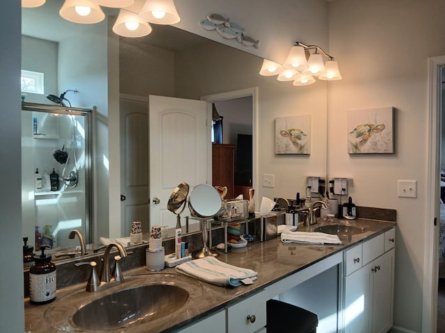 bathroom with an inviting chandelier, a sink, and double vanity