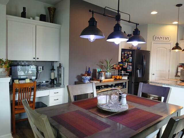 dining space featuring recessed lighting