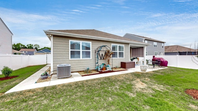 rear view of property featuring central AC unit and a patio area