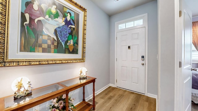entrance foyer featuring wood finished floors and baseboards