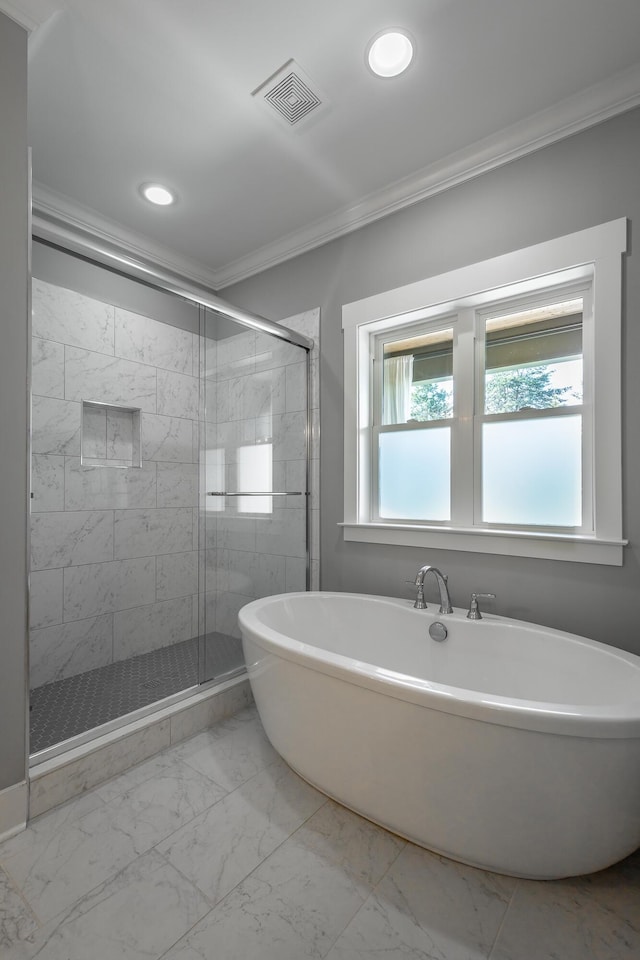 full bath featuring marble finish floor, visible vents, ornamental molding, a soaking tub, and a stall shower