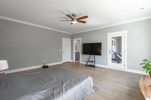 bedroom featuring wood finished floors, visible vents, ornamental molding, baseboards, and ceiling fan