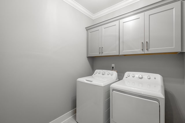 washroom with washing machine and dryer, baseboards, cabinet space, and ornamental molding
