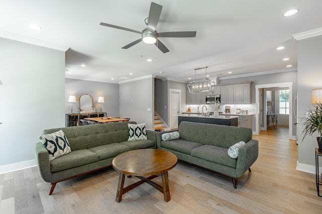 living area with baseboards, recessed lighting, light wood-style floors, ceiling fan, and crown molding