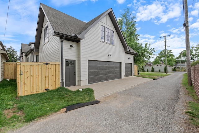 848 Bradford Ave, Nashville, TN 37204 - view of property exterior featuring a garage, a shingled roof, a gate, driveway, and fence