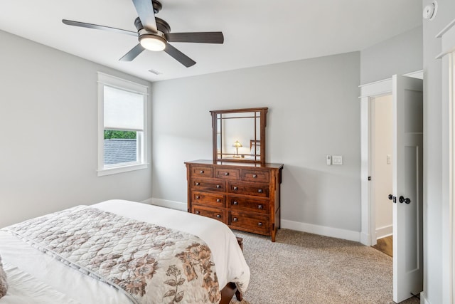 carpeted bedroom featuring baseboards and ceiling fan