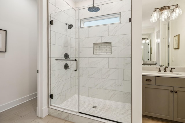 full bathroom featuring baseboards, vanity, and a stall shower