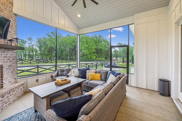 sunroom / solarium featuring an outdoor living space with a fireplace, ceiling fan, and a wealth of natural light