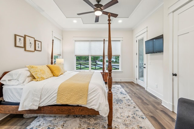 bedroom with wood finished floors, access to outside, recessed lighting, and ornamental molding