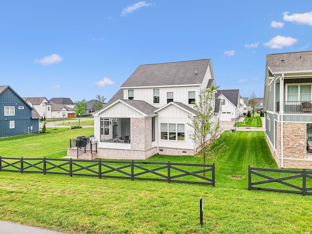 rear view of house with a residential view, a lawn, and crawl space