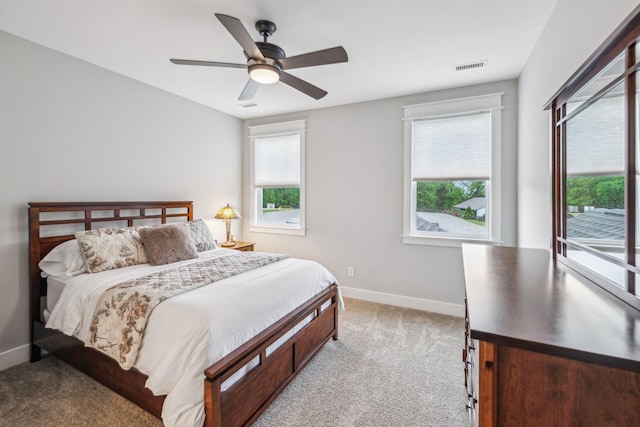 bedroom with baseboards, carpet flooring, and multiple windows