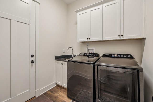 laundry area featuring cabinet space, independent washer and dryer, dark wood-type flooring, and a sink