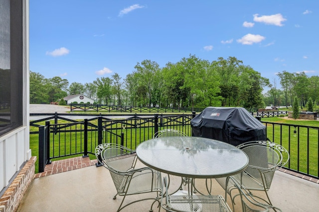 balcony with outdoor dining area and a grill