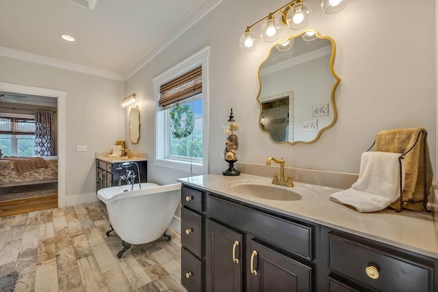 full bathroom featuring wood finished floors, a healthy amount of sunlight, ornamental molding, and ensuite bathroom