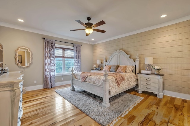 bedroom with baseboards, wooden walls, and recessed lighting