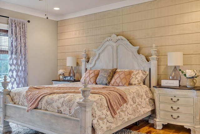bedroom featuring wood finished floors and ornamental molding