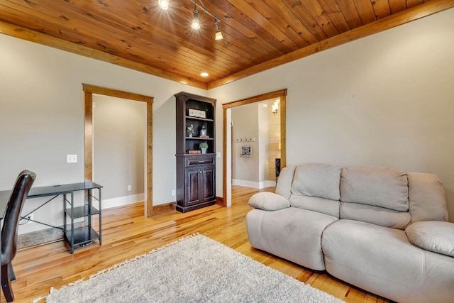 living room featuring light wood finished floors, baseboards, and wooden ceiling