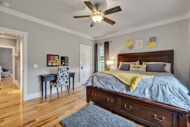 bedroom with light wood-style floors, ornamental molding, baseboards, and ceiling fan