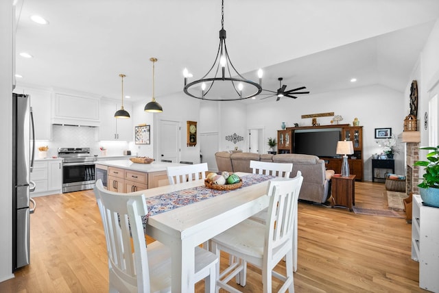 dining space featuring an inviting chandelier, light wood-style flooring, and recessed lighting