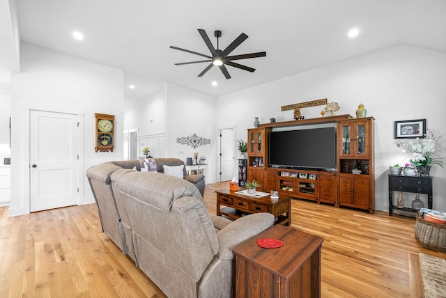 living room featuring high vaulted ceiling, ceiling fan, light wood-style floors, and recessed lighting