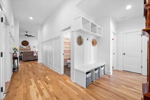 mudroom with a ceiling fan, recessed lighting, light wood-style floors, and a fireplace